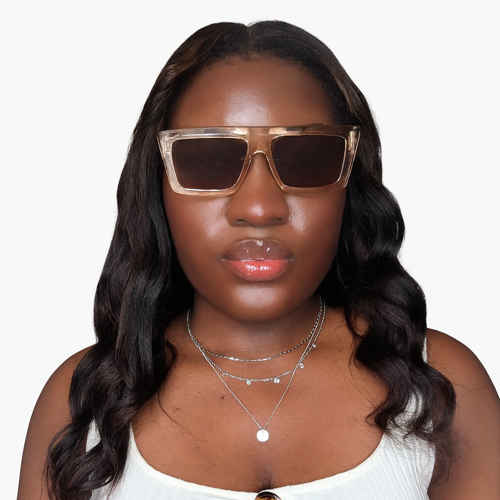 Woman wearing tan sunglasses and a white top with wooden buttons on a white background